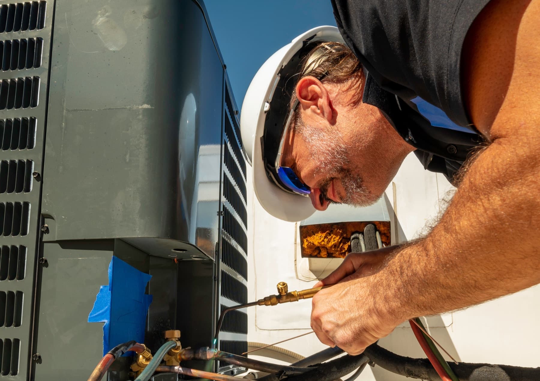HVAC technician servicing an outdoor unit